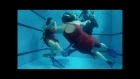 A man and two women are dancing in scuba
