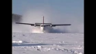 Twin Otter landing frozen lake with wheel-skis